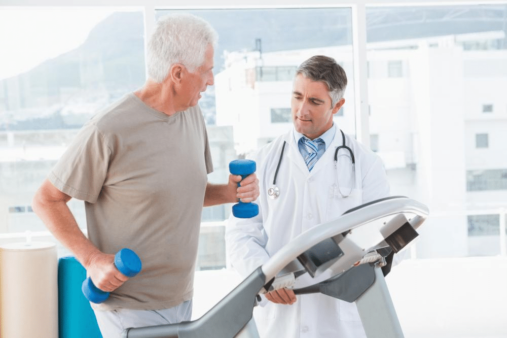 a senior man on a treadmill with a therapist for a physical exam